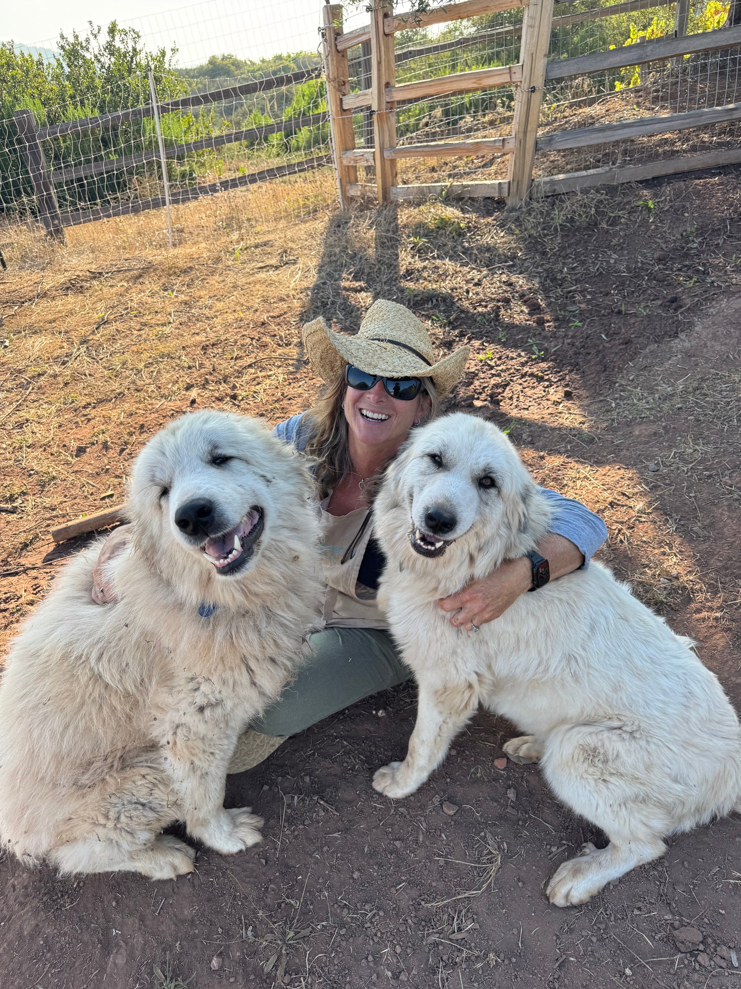 Organic and regenerative farmer of Wanderment Farms with her two livestock guardian dogs
