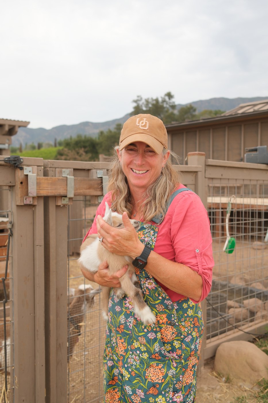 Margo holding Everdeen, the newest baby goat at Wanderment Farms